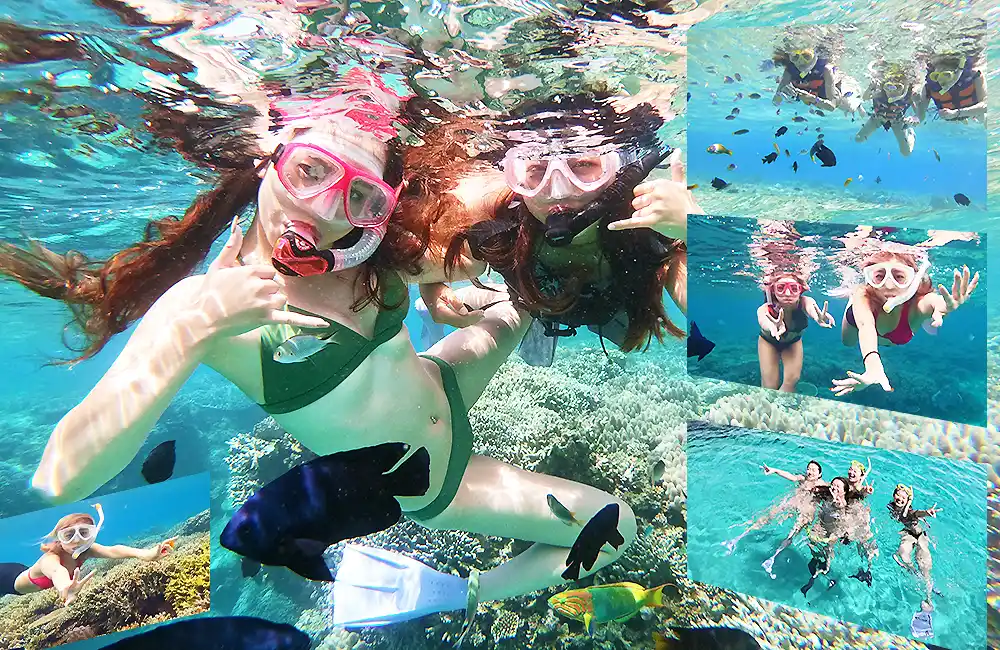 色とりどりのお魚に囲まれ、天国のような沖縄の水中世界に感動しているシュノーケリングの写真